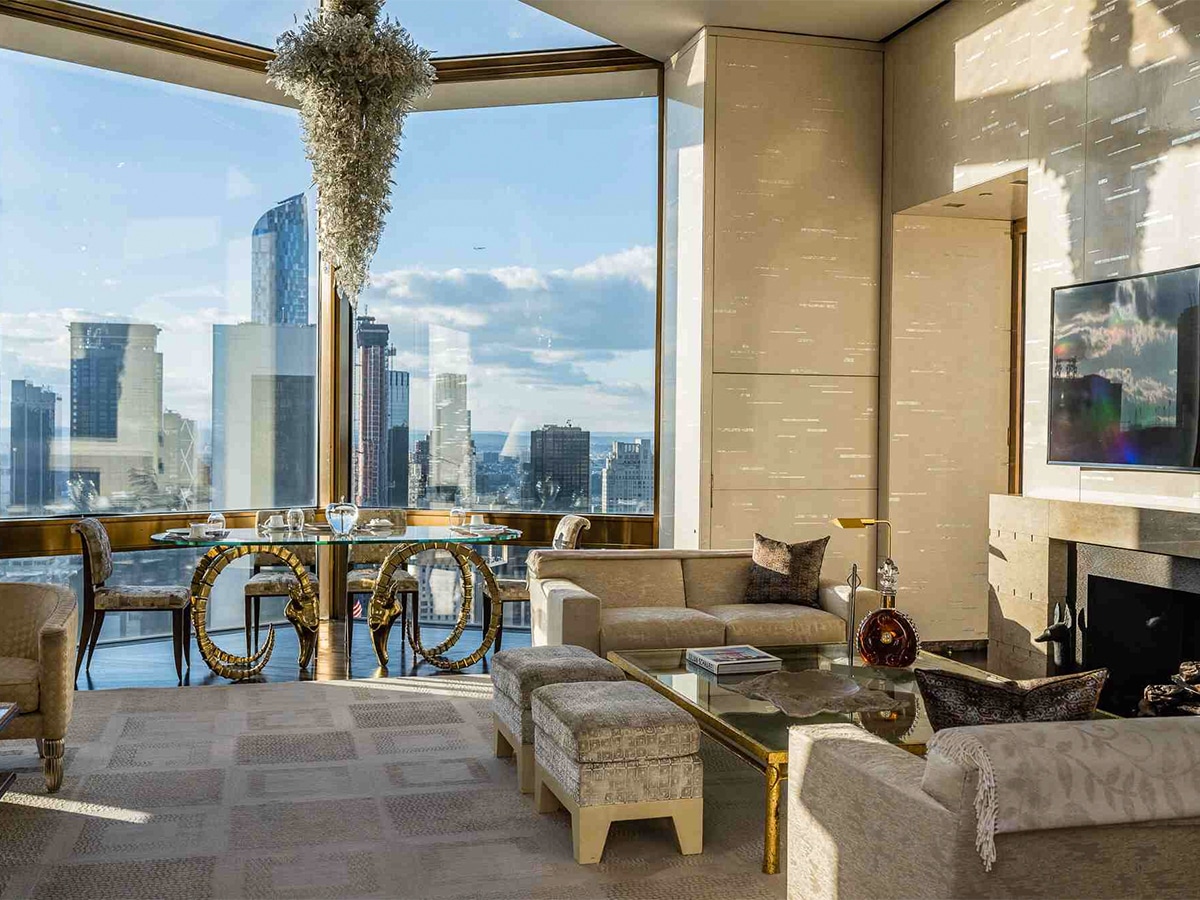 Interior of Ty Warner Penthouse – The Four Seasons Hotel lounge with expansive glass windows showing cityscape at daytime