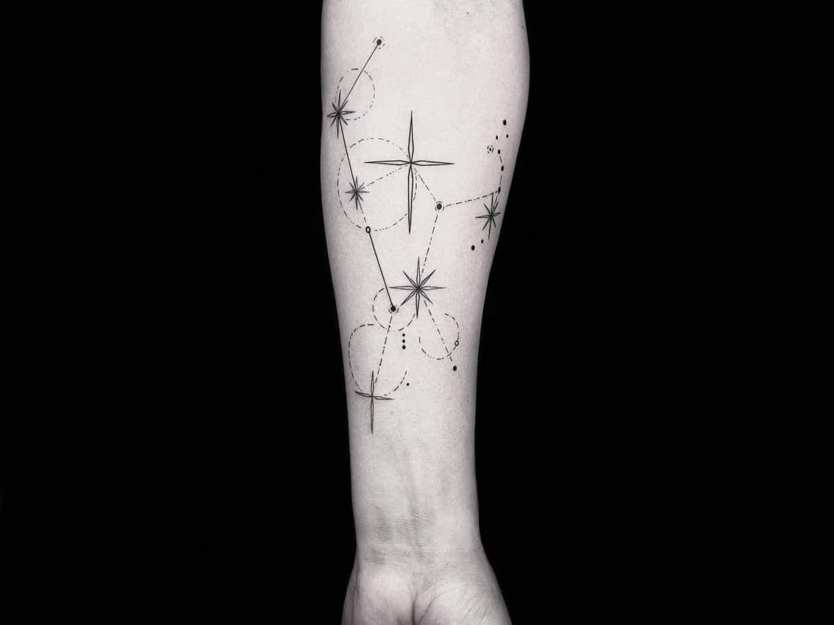 Close up of man’s arm with constellation line work tattoo design