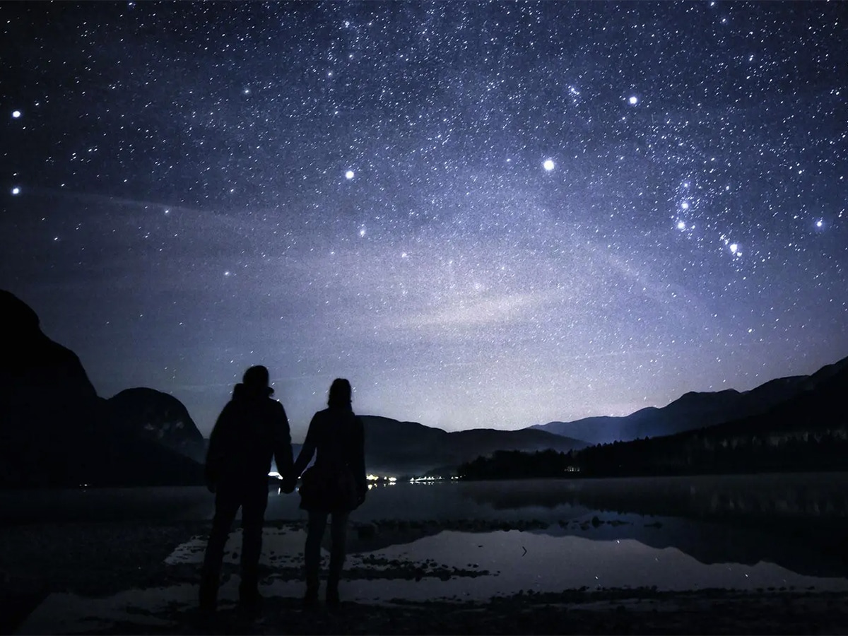 Silhouette of couple stargazing