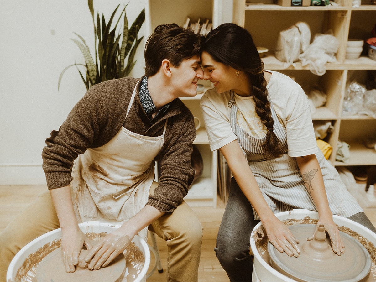 Couple at a clay studio trying pottery making together