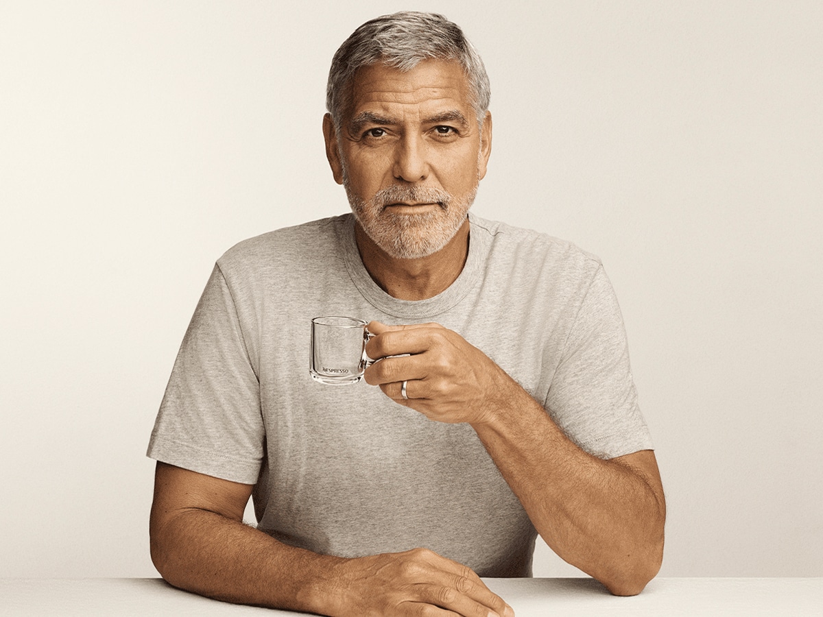 George Clooney holding an empty cup