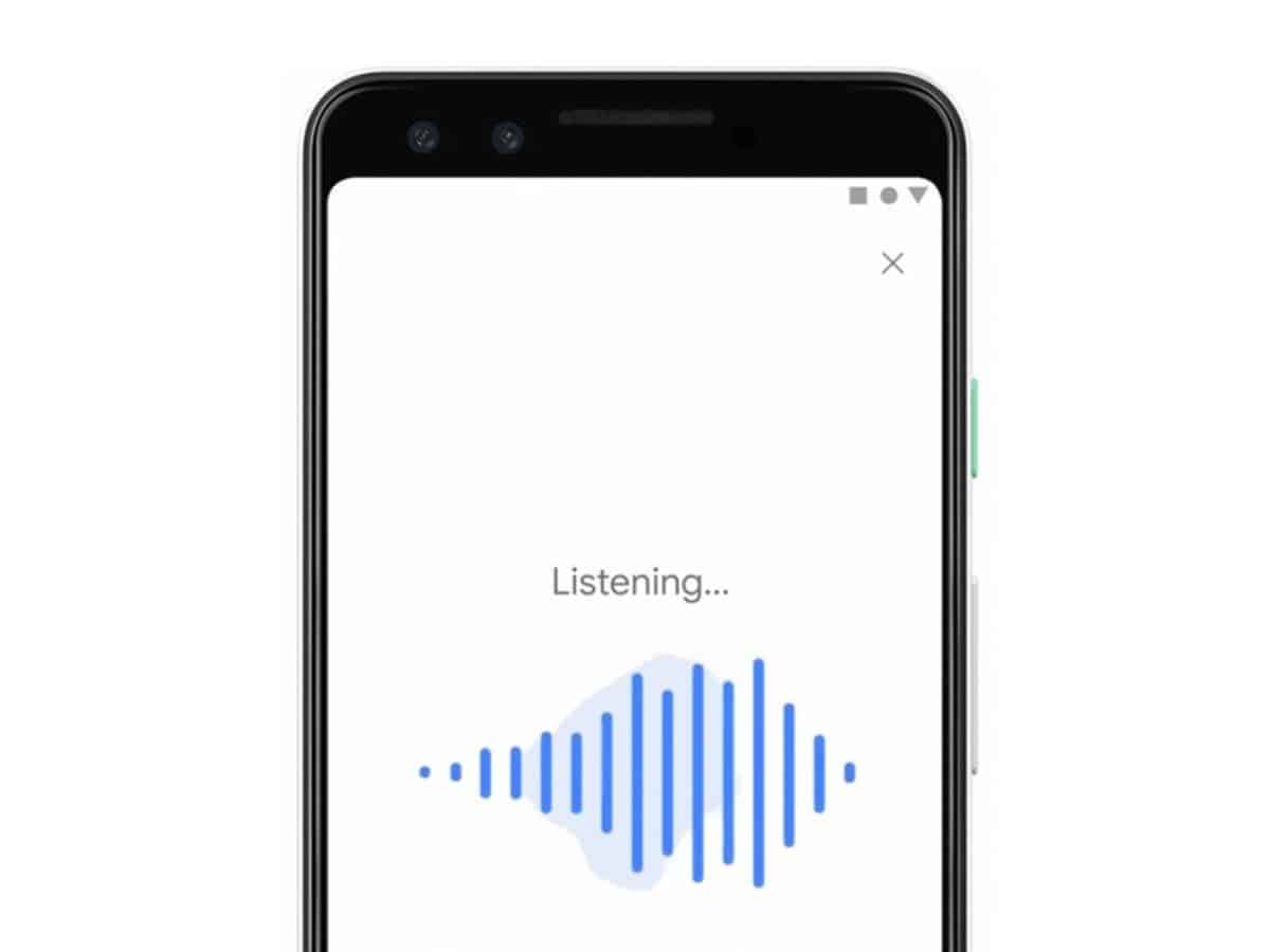 Phone screen showing Google app with text ‘Listening…’ below blue sound waves animation