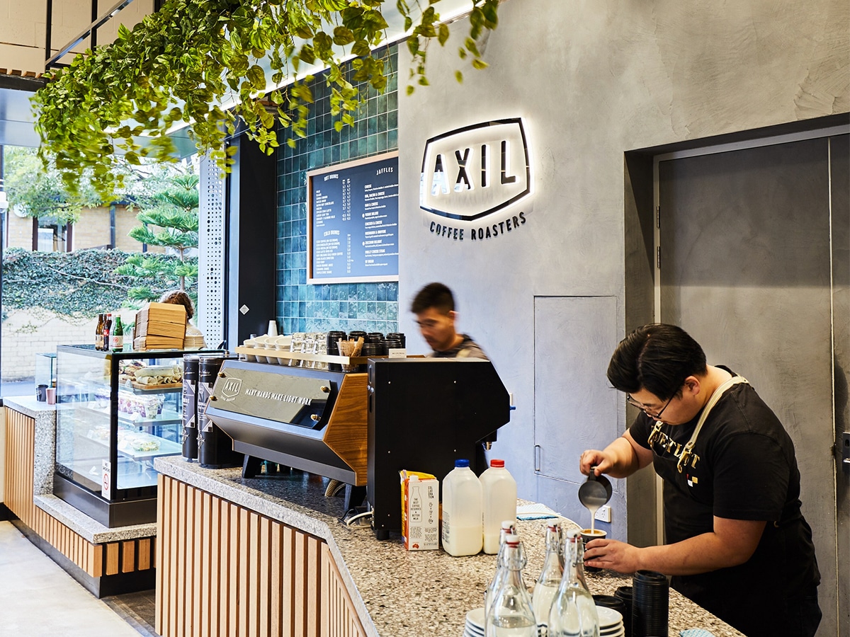 Interior of Axil cafe with three staff behind the bar area