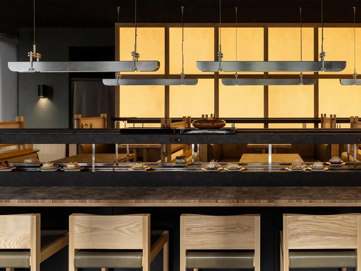 Interior of Sakura Kaiten Sushi Japanese restaurant with sushi bar and chairs