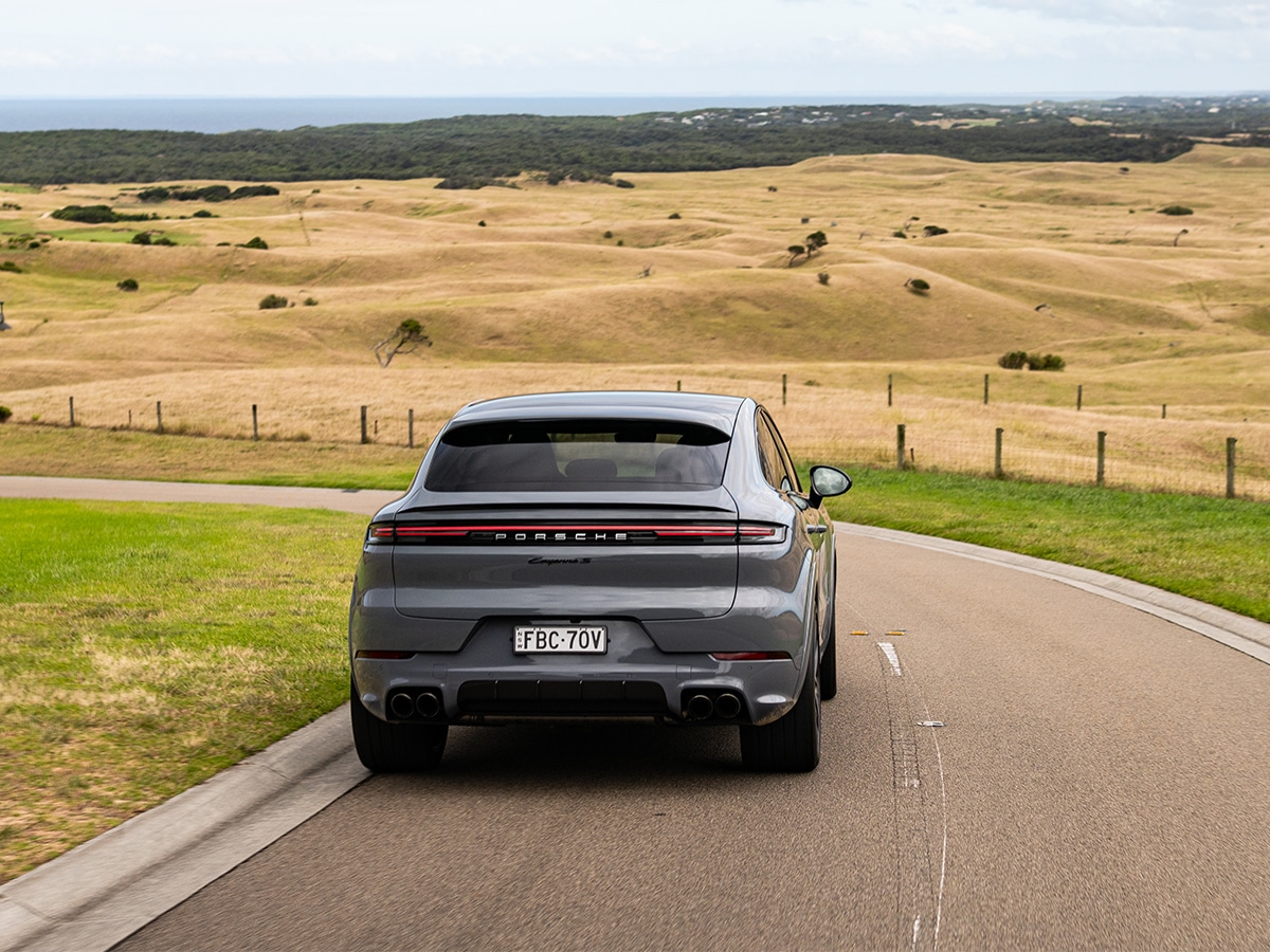 2024 porsche cayenne coupe driving on the road rear end