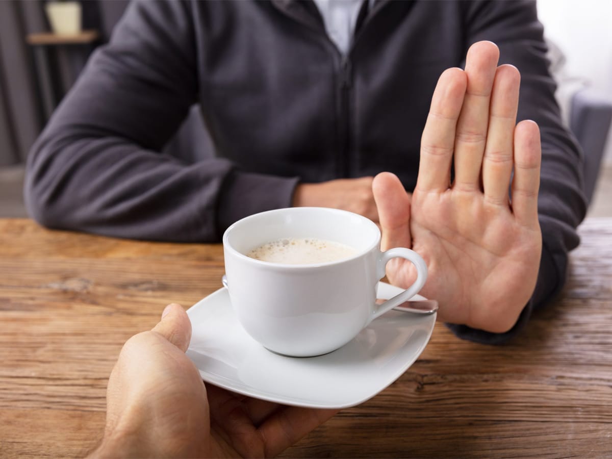 Hand declining a cup of coffee