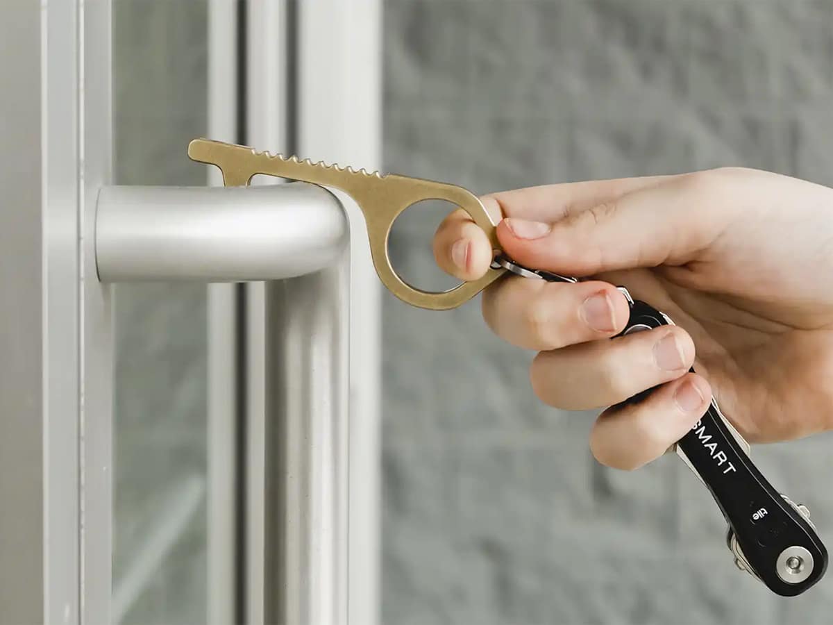 Keysmart CleanKey Antimicrobial Hand Tool hooked on a door handle