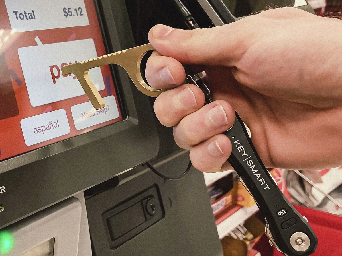 Keysmart CleanKey Antimicrobial Hand Tool used to press on an ATM