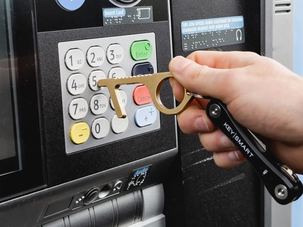 Keysmart CleanKey Antimicrobial Hand Tool used to press on an ATM