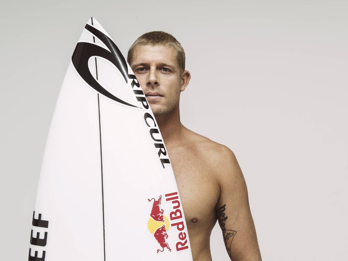 Mick Fanning holding a surf board