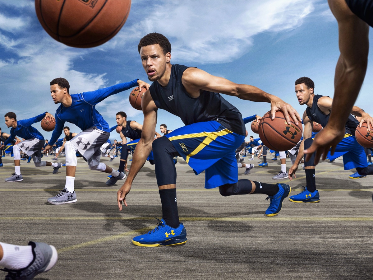Multiple clones of Stephen Curry dribbling a basketball