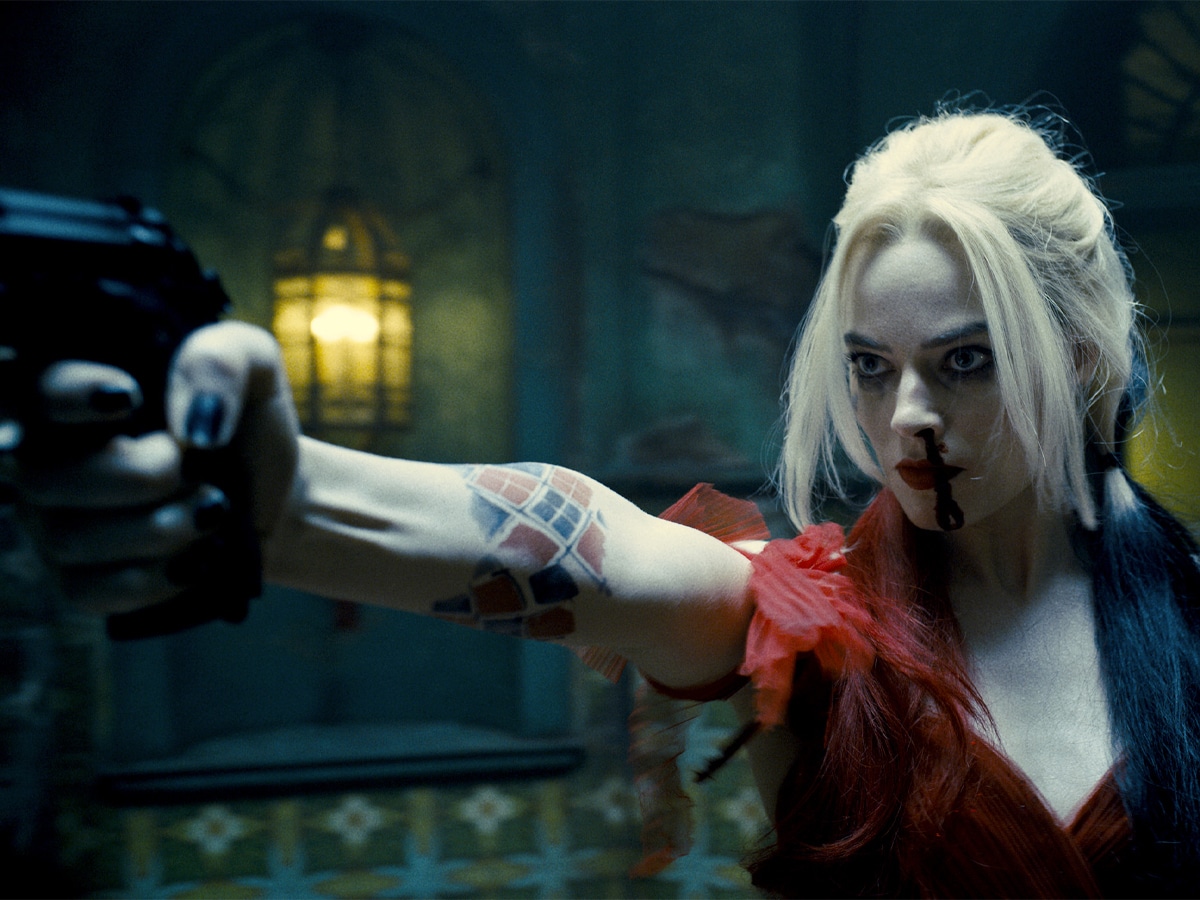 Margot Robbie as Harley Quinn holding a gun in ‘The Suicide Squad’