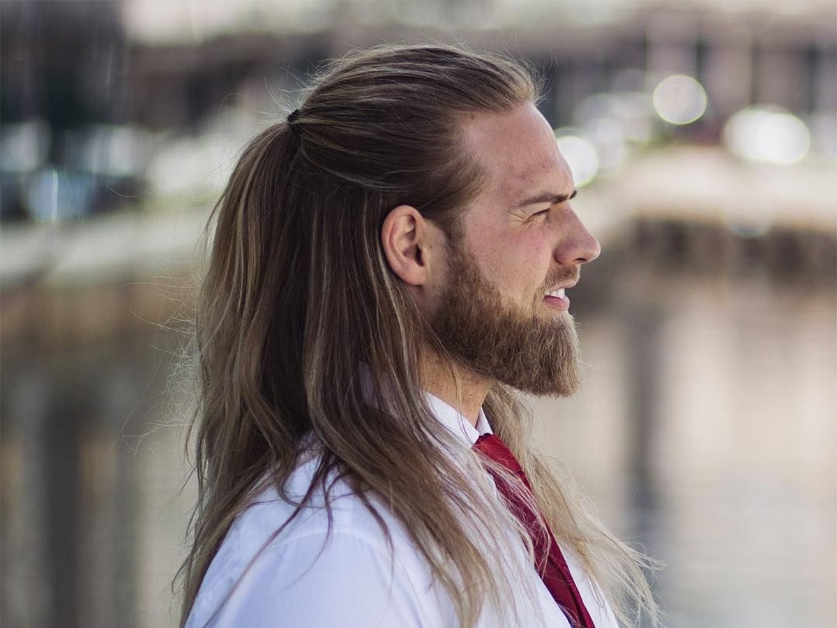 Side view of a man with a half down half up hairstyle