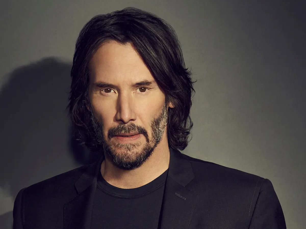 Keanu Reeves with with long hair and beard