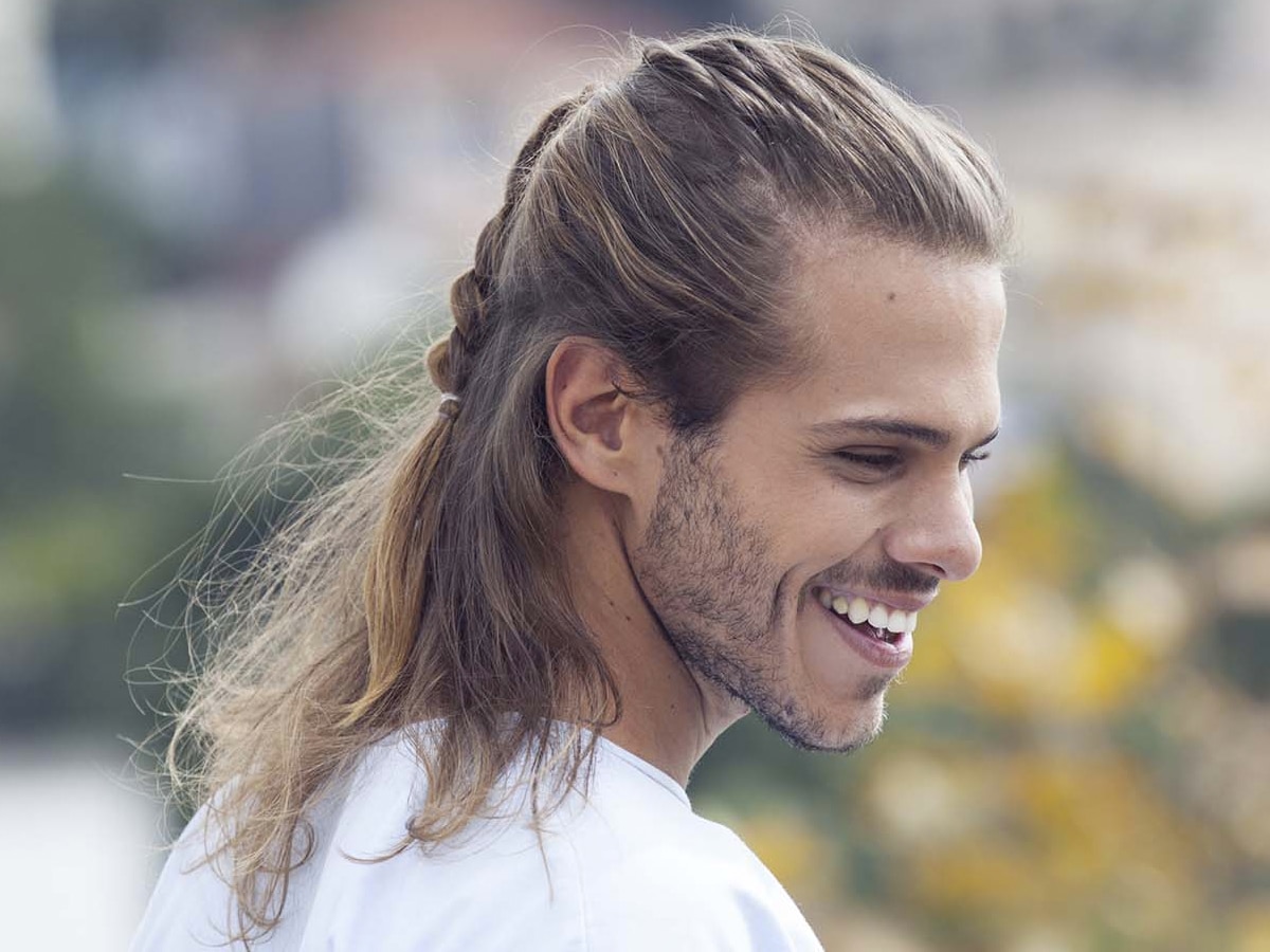 Young man with long hair in a half pony hairstyle