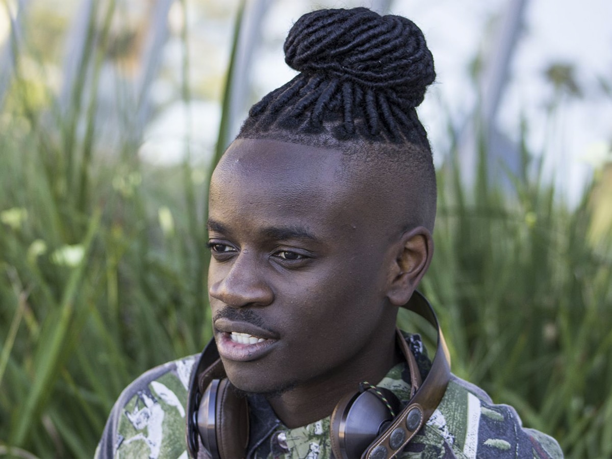 Young man with dreadlocks in a bun