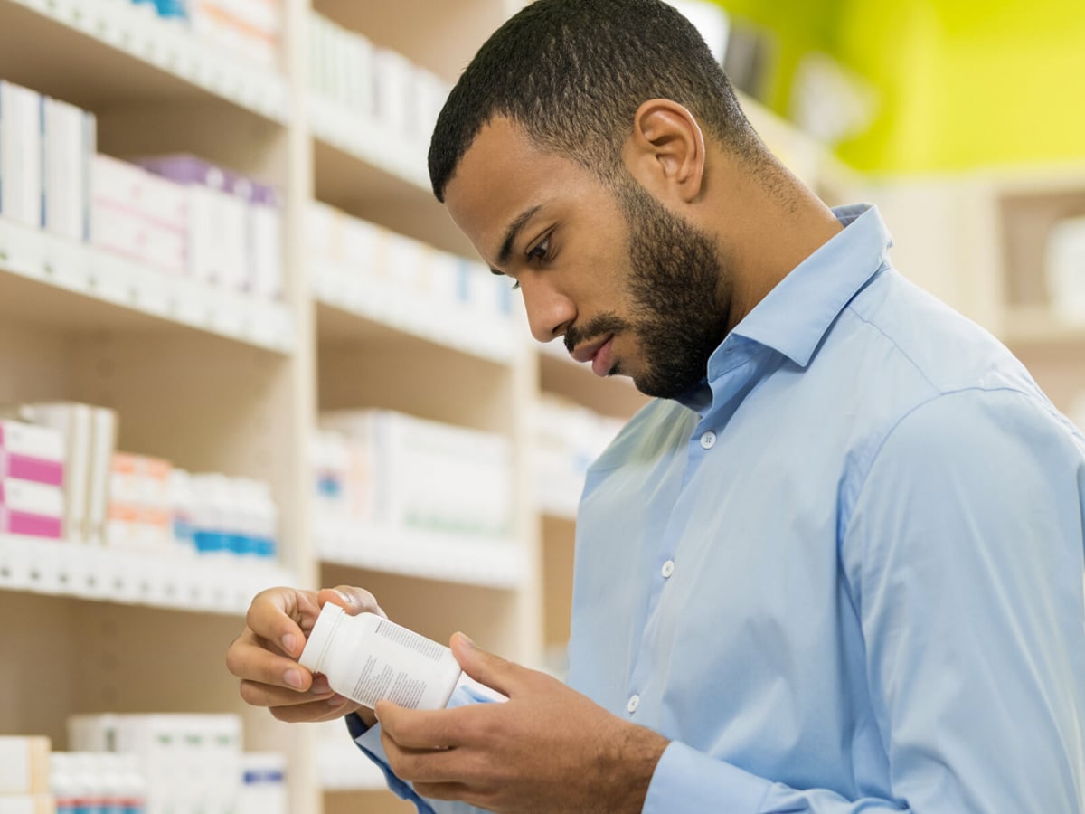 Man examining a pill bottle