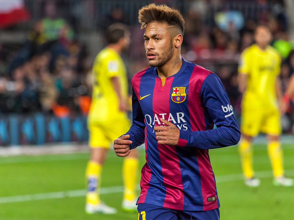 Medium shot of Neymar in his blue and red Qatar airways jersey