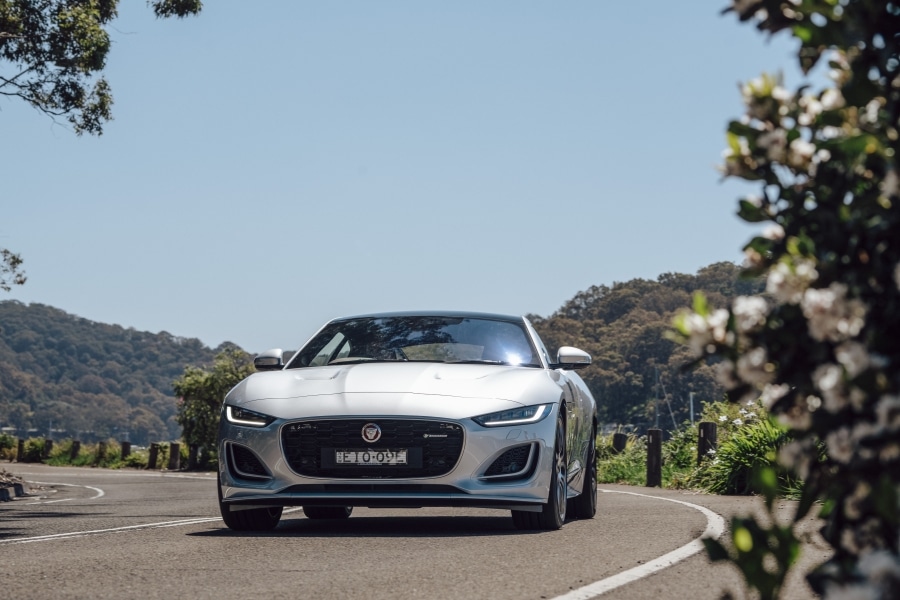 Front view of the silver 2021 Jaguar F-type, driving on the road