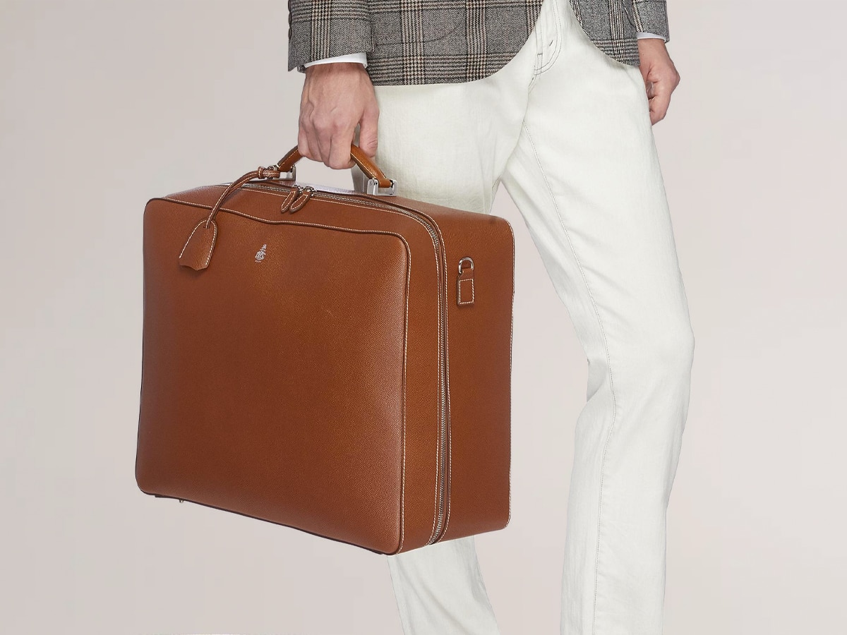 Model carrying Mark Cross travel bag