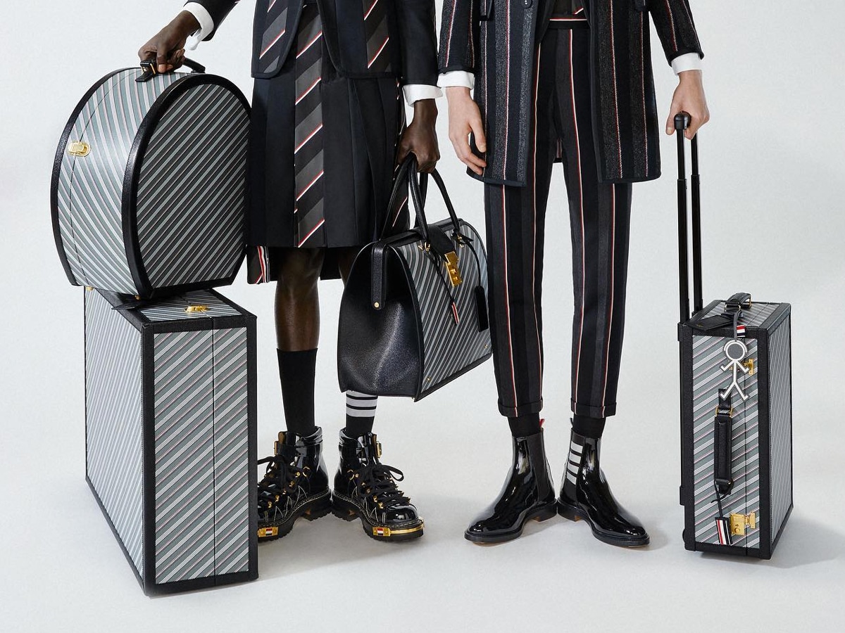 Two models carrying Thom Browne luggage