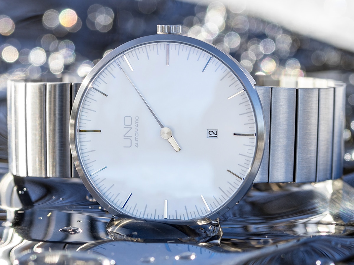 Botta Design silver watch with glass bokeh effect background
