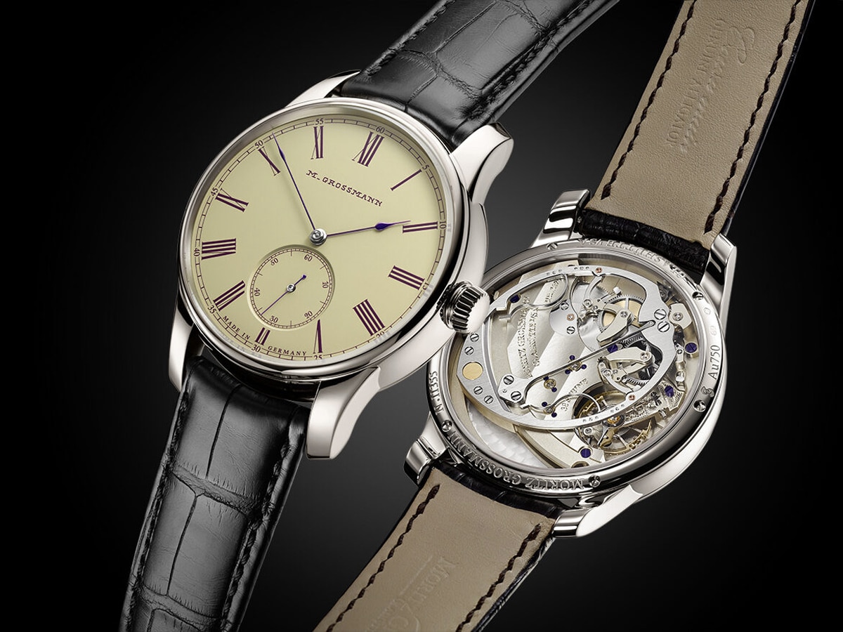 Front and back view of a Moritz Grossmann watch side by side against a black background