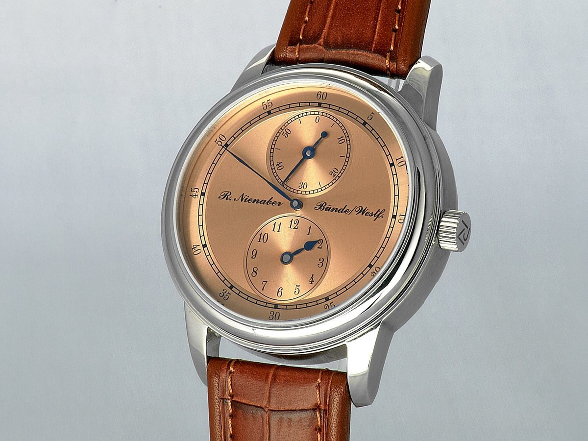 Rainer Nienaber watch with brown leather straps against grey background