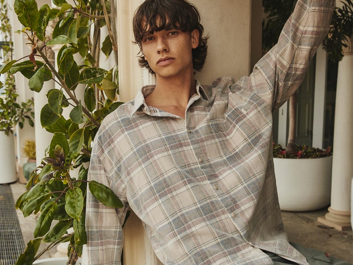 Male model wearing plain shirt in neutral colours