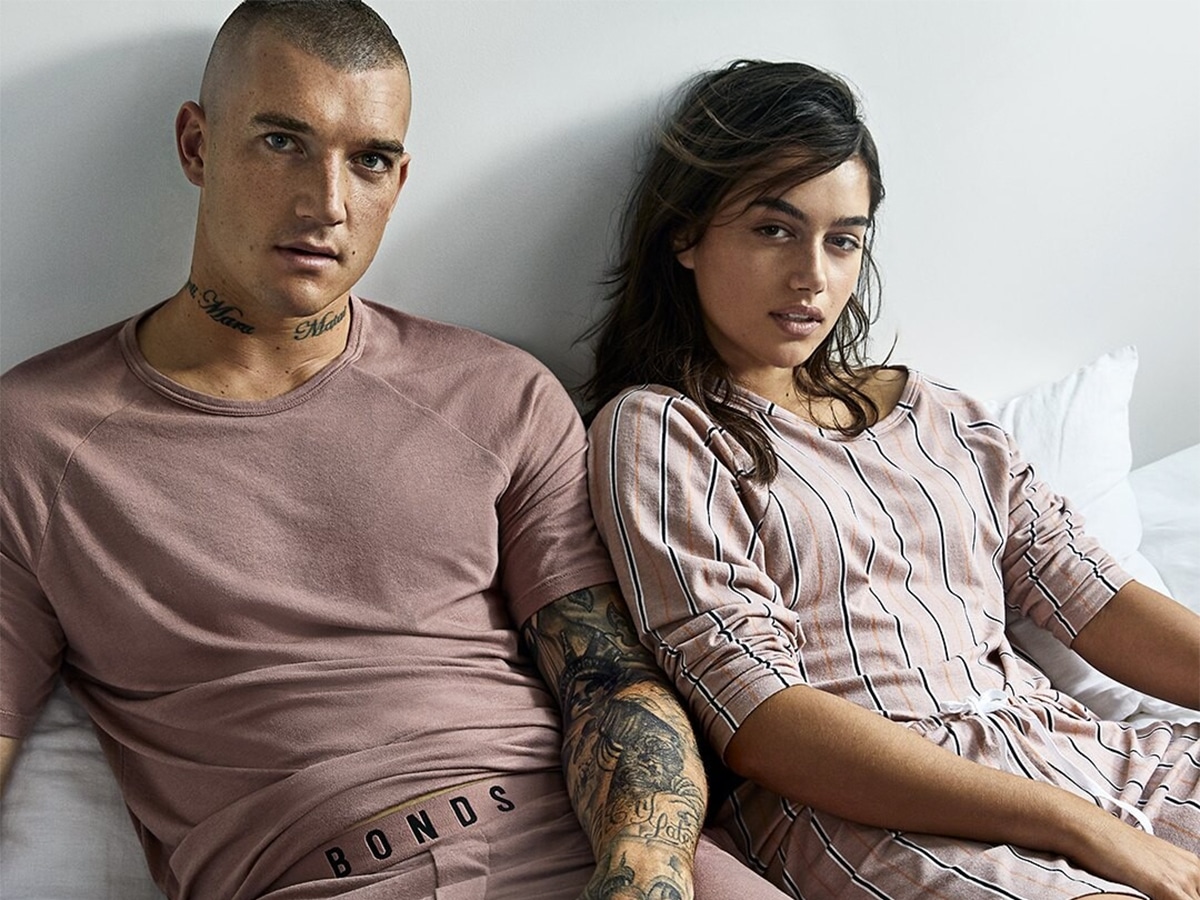 Male and female model wearing pink undergarments