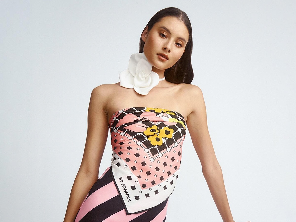 Female model wearing fitted dress with geometric design print