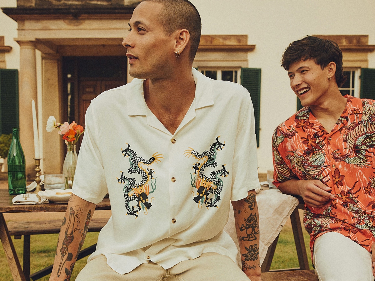 Two male models wearing dragon printed shirts