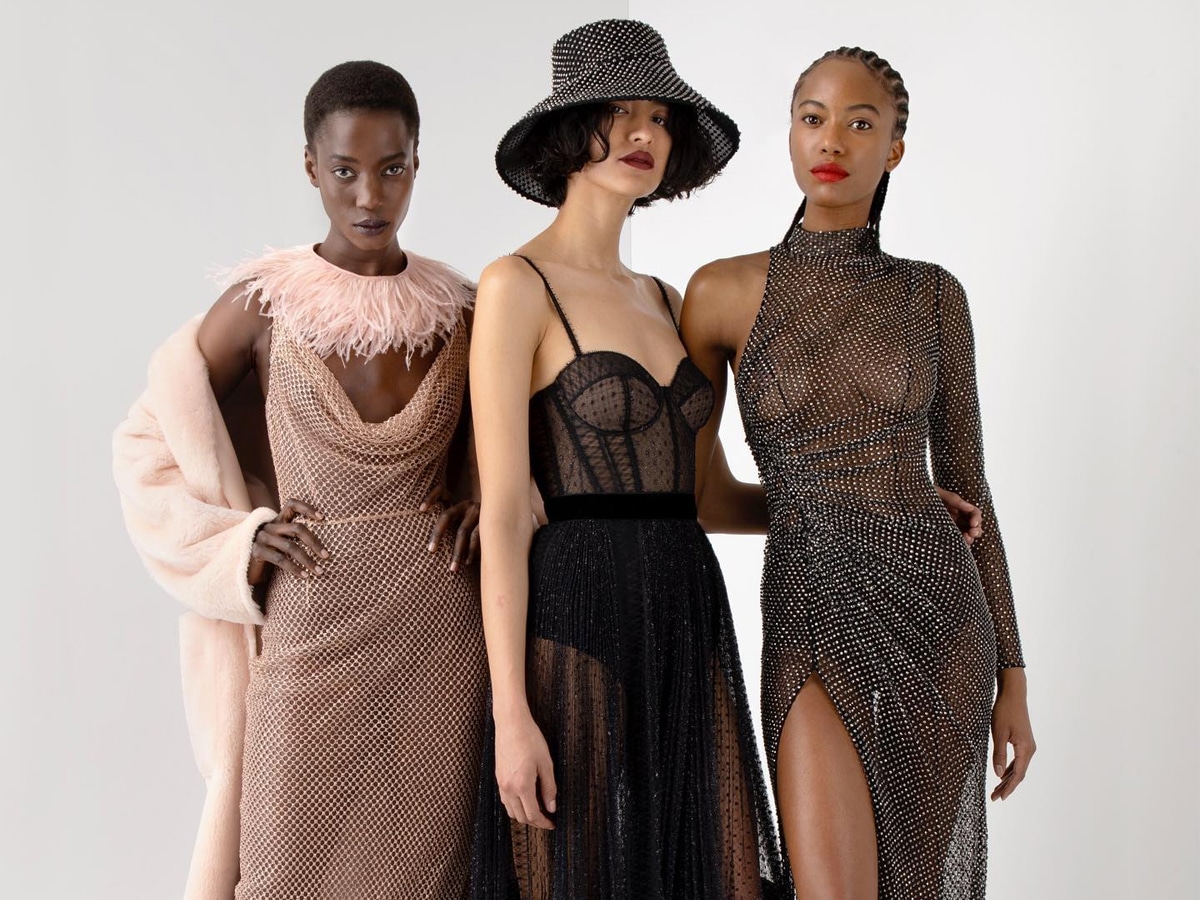 Three female models wearing different haute couture dresses