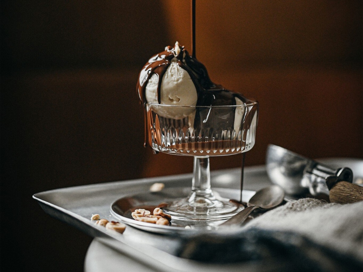 Chocolate dripping over vanilla gelato