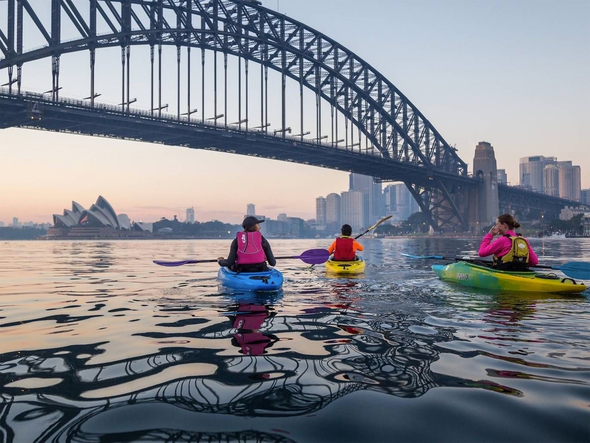 Three people paddling around Sydney Harbour by Kayak