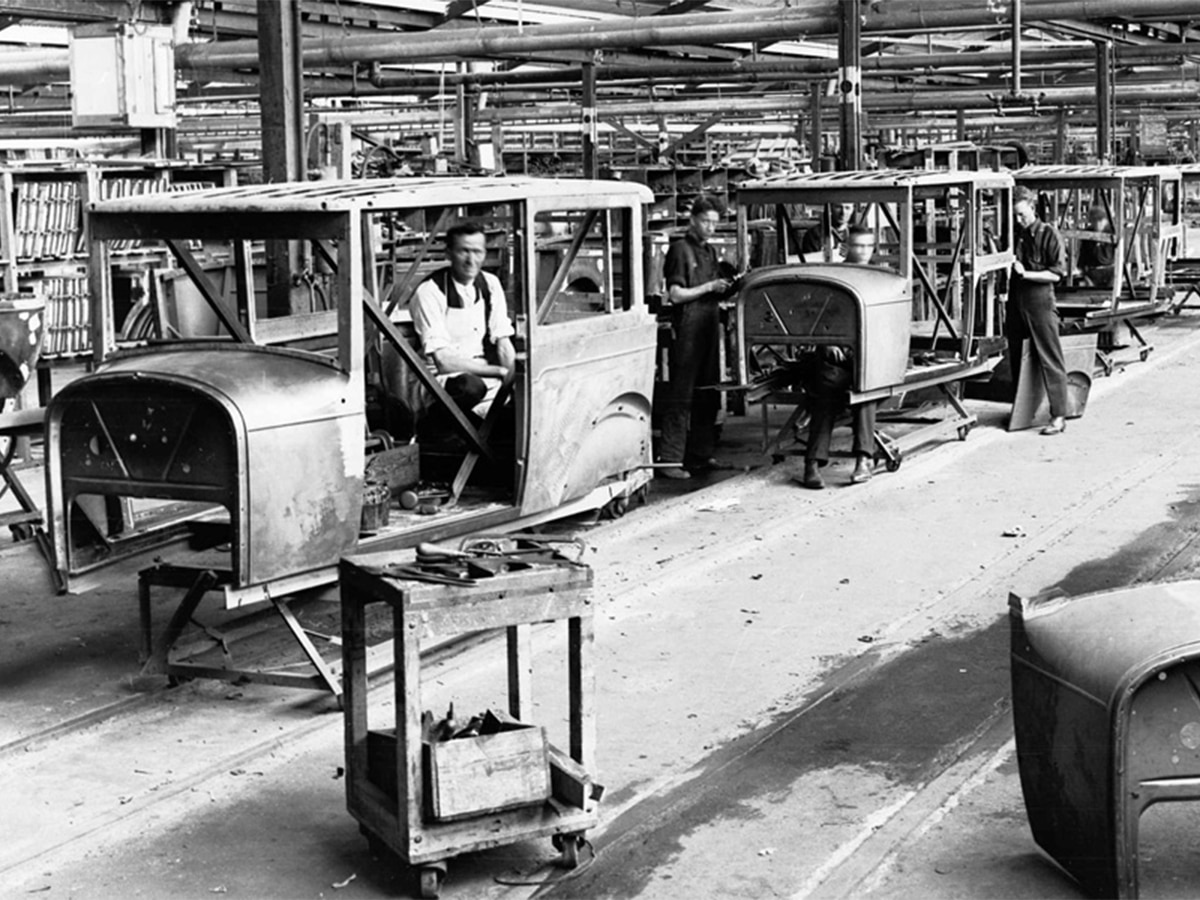 Greyscale image of car manufacturing in the past