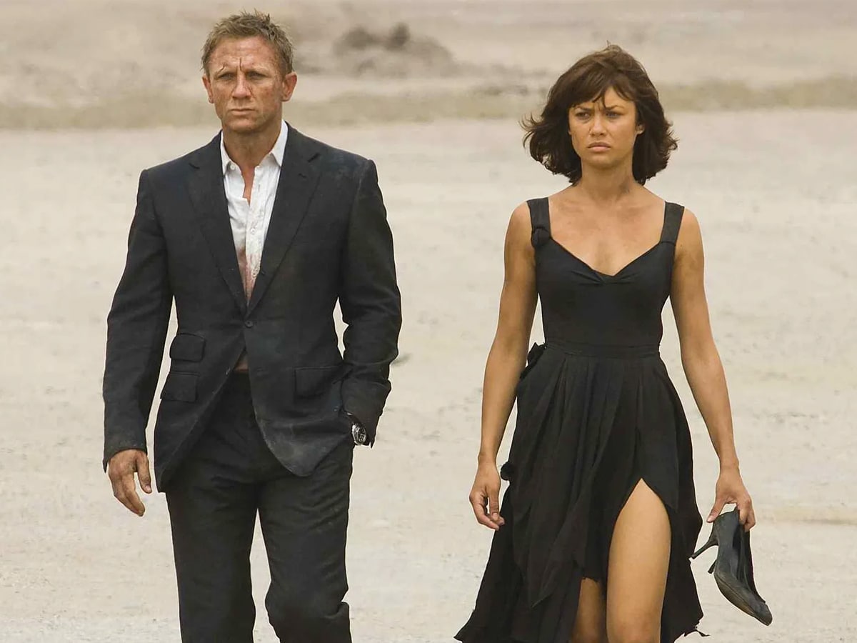 Olga Kurylenko in a black dress with James Bond actor