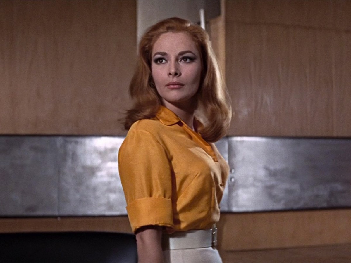 Karin Dor in a yellow top and white skirt