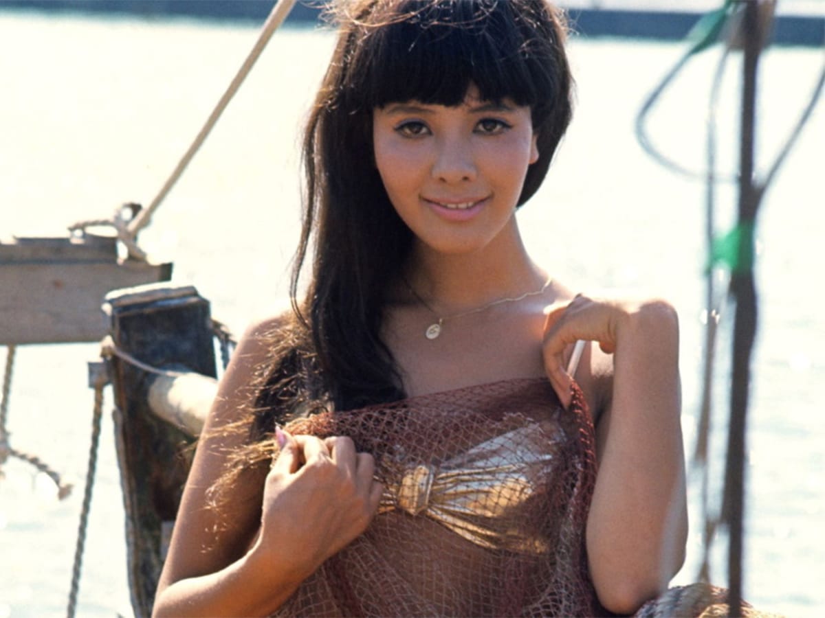 Mie Hama in a bikini holding a fish net