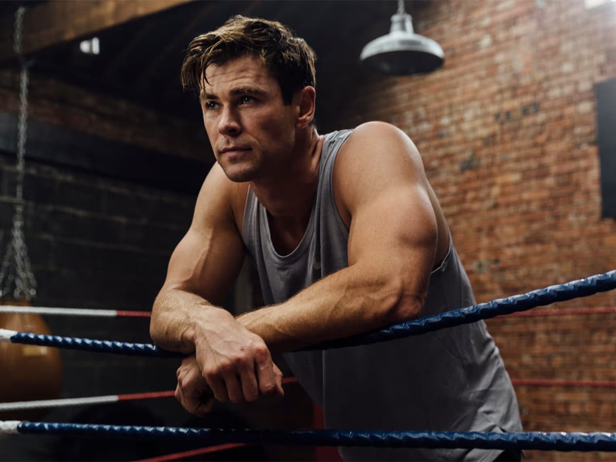 Chris Hemsworth leaning on boxing ring fence
