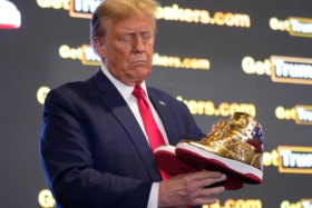 Donald trump sneakers in hand