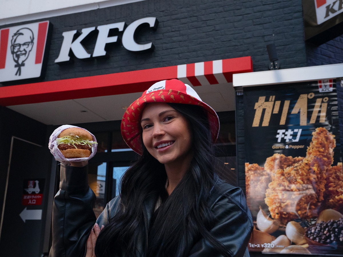 Kentucky Fly Chicken winner Lisa Wenban with the 'cult' KFC Wafu Cutlet Burger in Japan | Image: KFC Australia