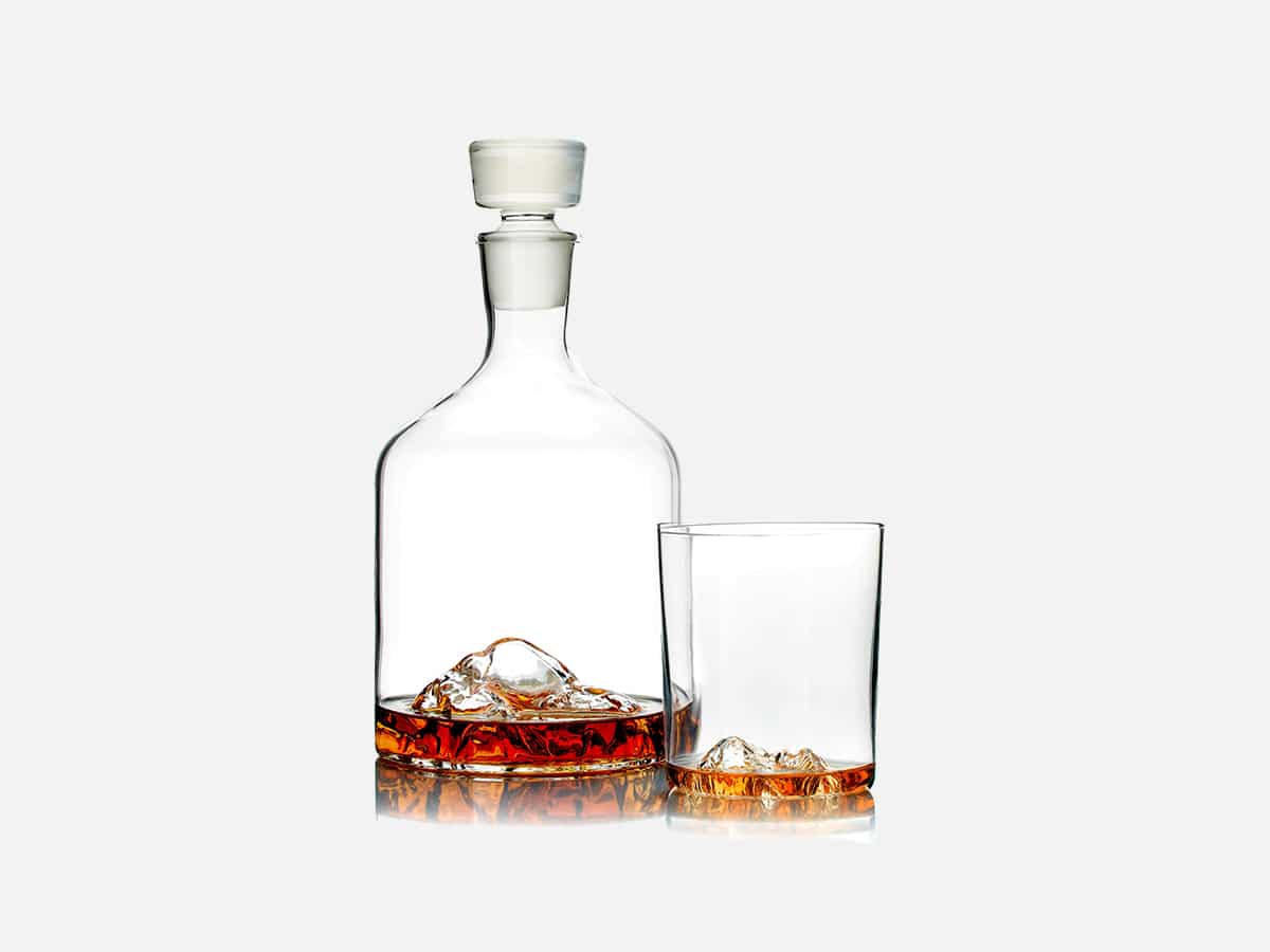 Whiskey peaks decanter and glass next to eachother