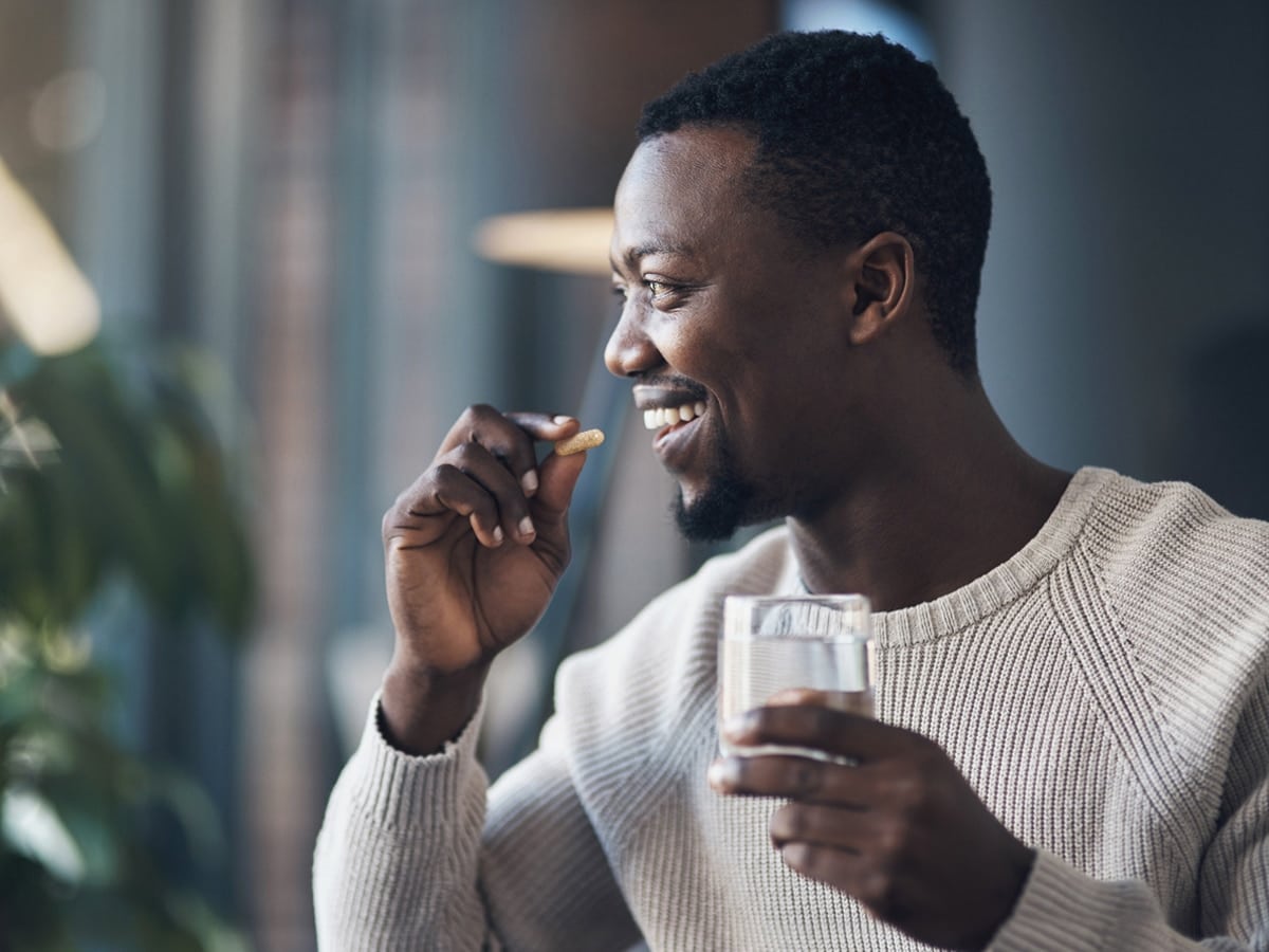 Man taking an ashwagandha tablet