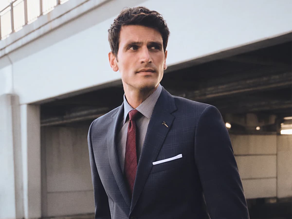 Male model in a dark blue patterned suit