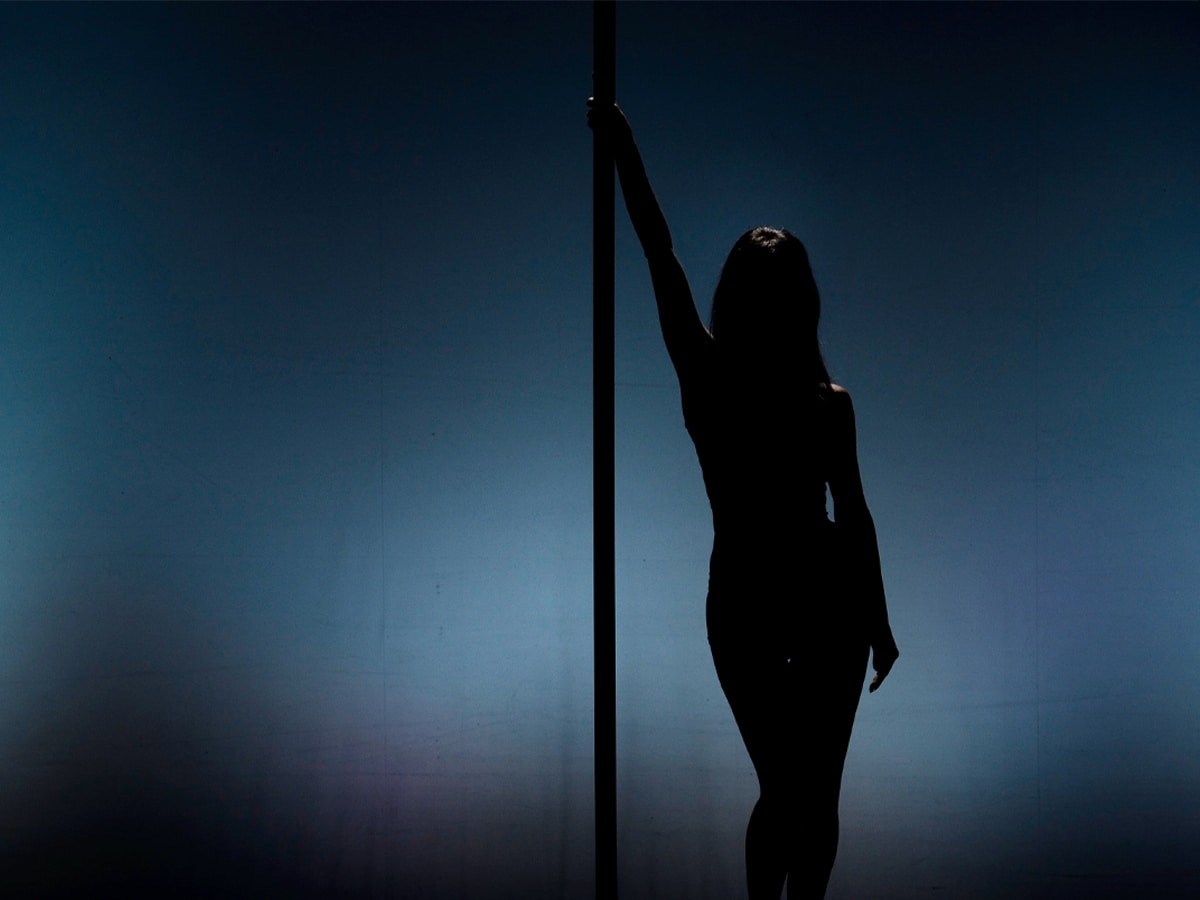 Silhouette of a female pole dancer