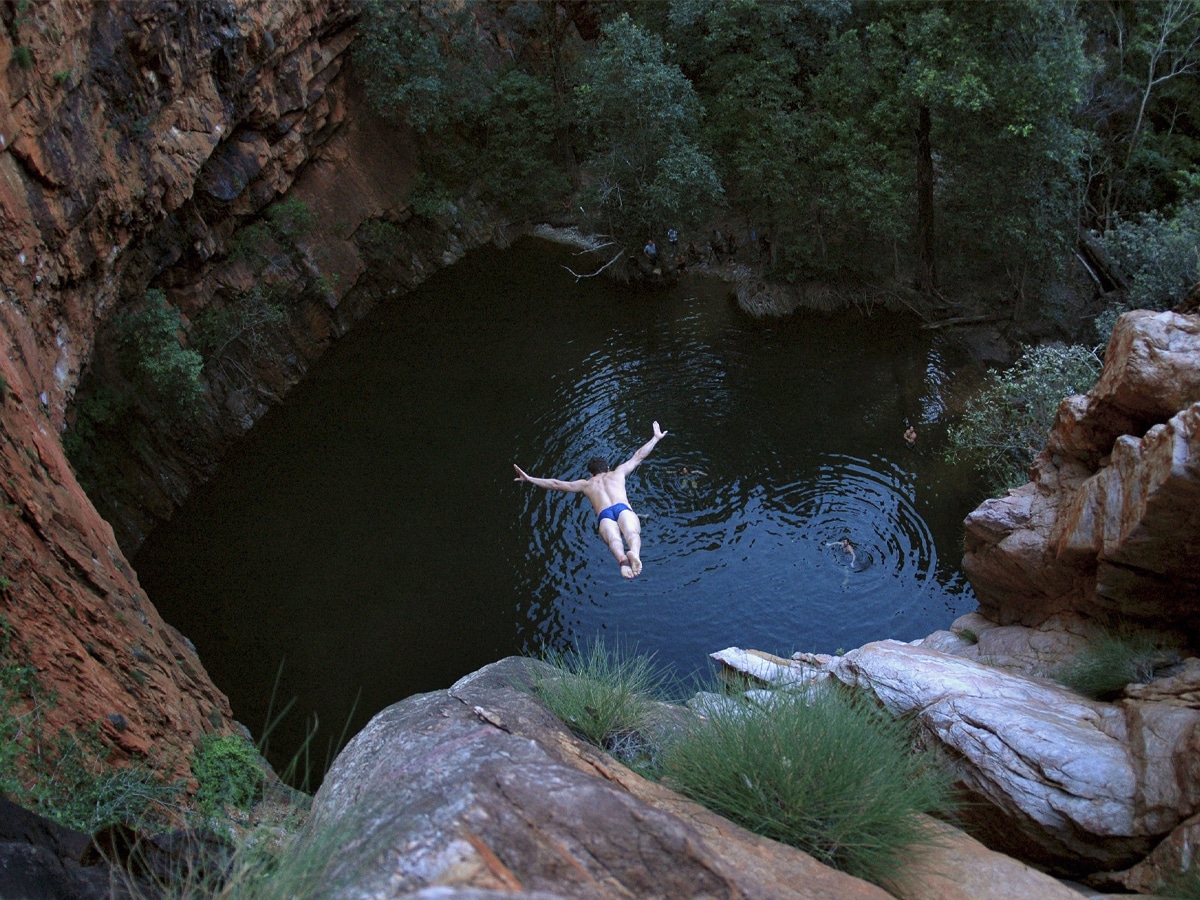 Man cliff jumping at Macquarie Pass Jump Rock