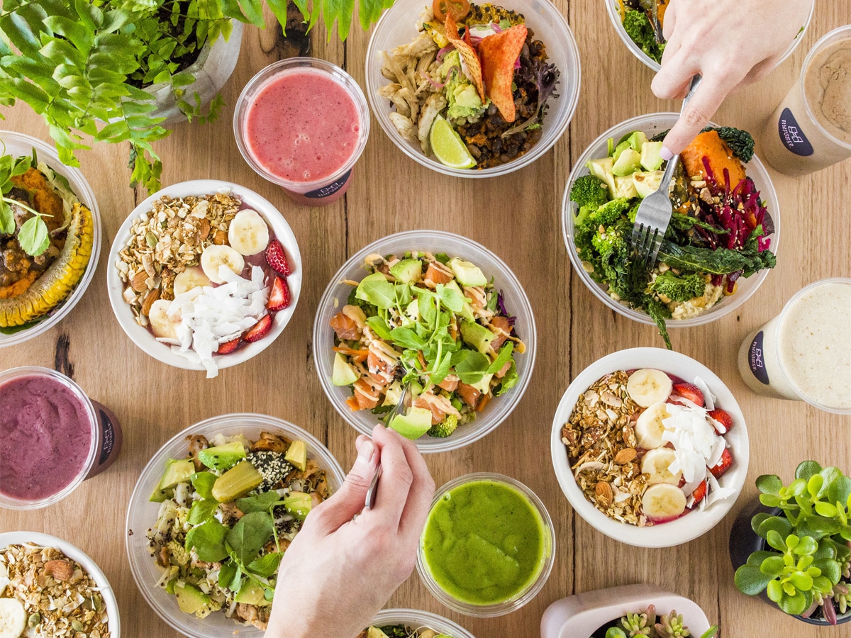 Overhead shot of multiple poke bowls on a wooden table
