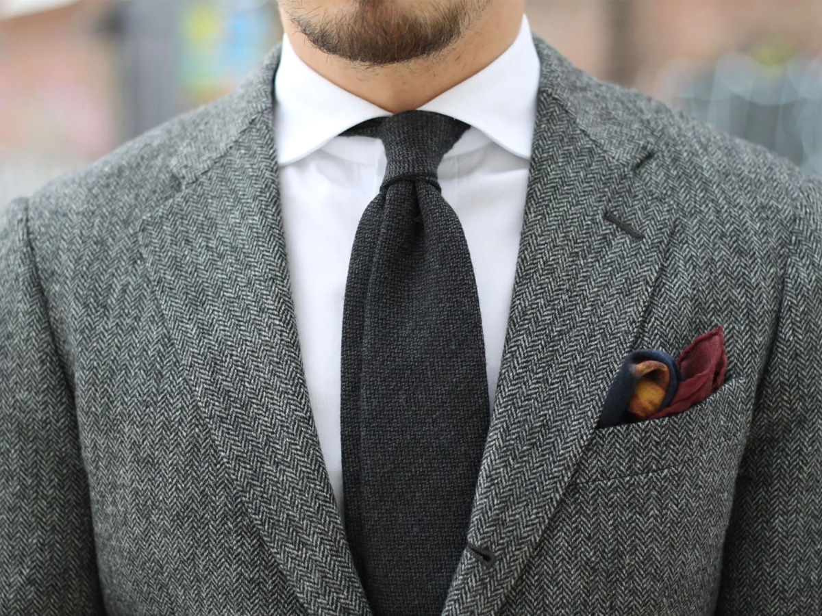 Man in a grey herringbone wool suit
