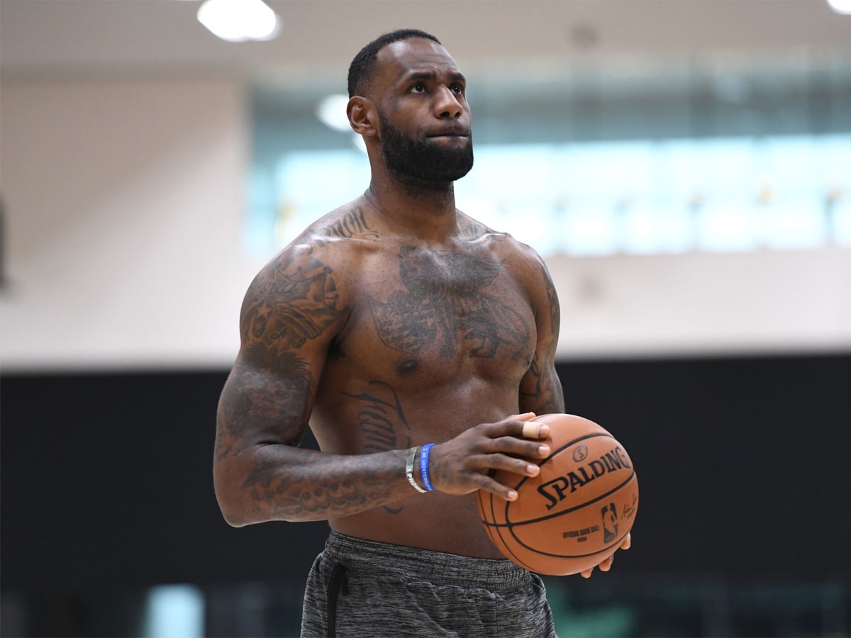 Shirtless LeBron James holding a basketball